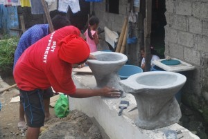 Relief workers build toilets in an effort to improve sanitation before the start of monsoon season. 
