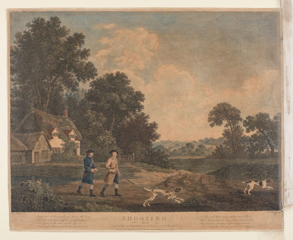Two men armed with guns walk towards a field across from a thatched cottage