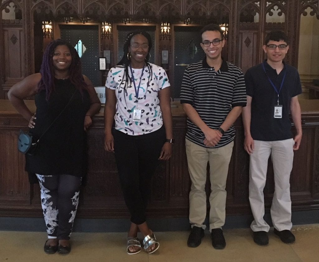 Four smiling students who are interns at Yale University Library though the New Haven Promise program.